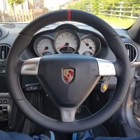 987997-Triangular-airbag-Black-Thicker-Thumb-grips-Added-Perforated-leather-on-sides-Smooth-too-bottom-Red-centre-stripe-at-12-oclock-Dark-grey-416-stitching