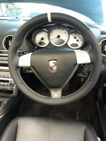 987997-Triangular-airbag-Black-Thicker-Thumb-grips-Added-Perforated-leather-on-sides-Smooth-too-bottom-White-centre-stripe-at-12-oclock-White-stitching-1