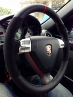 987,997 - thicker, thumb grips built up, black alcantara sides, smooth top-bottom + red centre Stripe at 12, silver 412 stitching