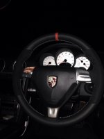 987,997 - thicker, thumb grips built up, black alcantara sides, smooth top-bottom + red centre Stripe at 12, silver stitching 2