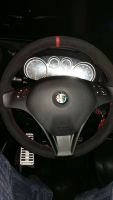 Alfa-Mito-cloverleaf-2011-Black-alcantara-Red-centre-stripe-at-12-oclock-Red-stitching