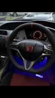 Civic-Type-R-FN2-–-Thicker-Thumb-grips-built-up-Flat-bottom-Perforated-leather-on-sidesSmooth-top-bottom-Red-centre-stripe-at12-oclock-Red-stitching-1