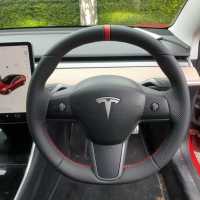 Tesla-model-3-2019-NON-heated-Perforated-leather-on-sides-Smooth-top-bottom-Red-centre-stripe-Red-stitching-1