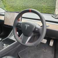 Tesla-model-3-2019-NON-heated-Perforated-leather-on-sides-Smooth-top-bottom-Red-centre-stripe-Red-stitching-2